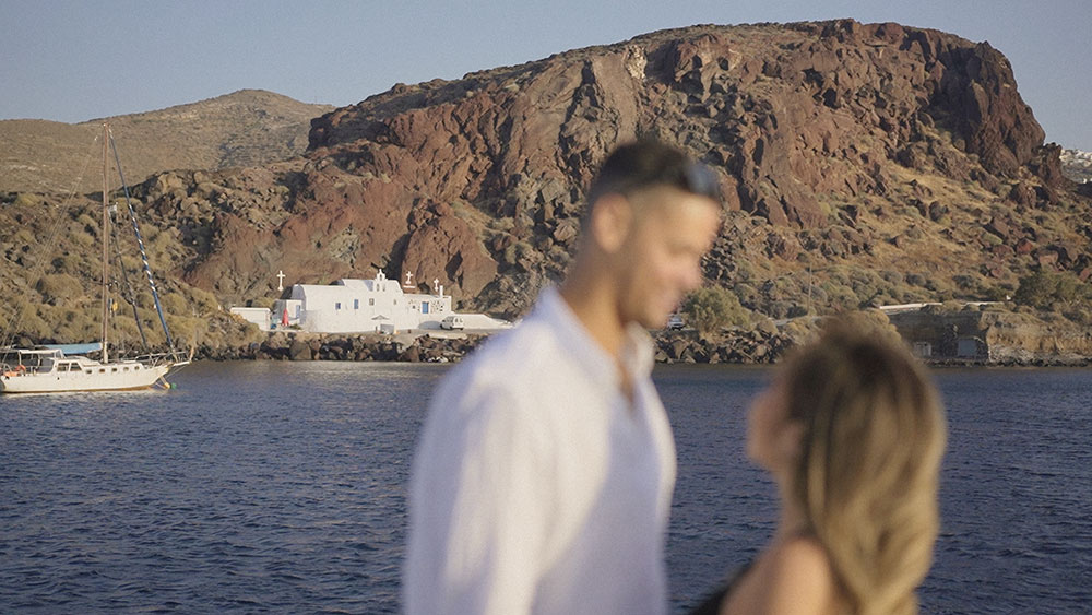 red beach santorini boat engagement wedding videographer