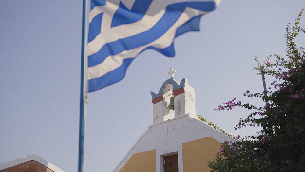 greece flag church santorini oia wedding videographer